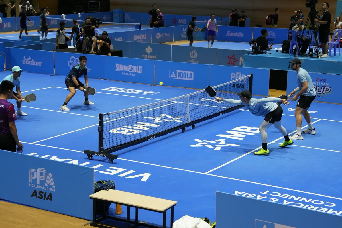 Pickleball players competing on an indoor court